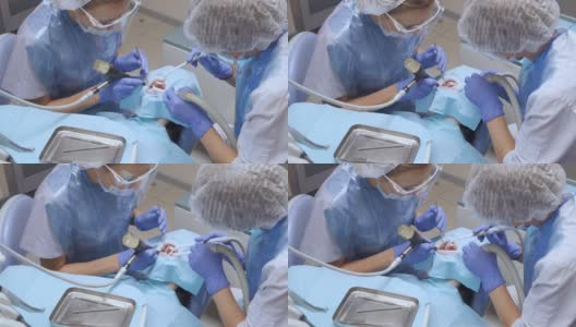 密切牙科医生穿戴防护服和手套协助病人进行牙科手术，并配合专家团队进行医疗传染病卫生慢动作高清在线视频素材下载