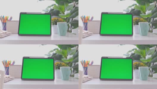 空白绿屏数字平板站在家里的工作台上，模拟，模板，技术概念高清在线视频素材下载