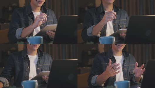 亚洲人在家里工作到很晚，在视频电话会议中使用笔记本电脑和数字平板电脑高清在线视频素材下载