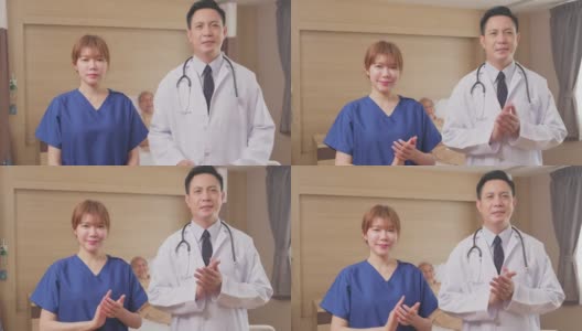 亚洲医生和护士微笑鼓掌鼓励病人的肖像。医疗队站在医院康复室的病床前。高清在线视频素材下载