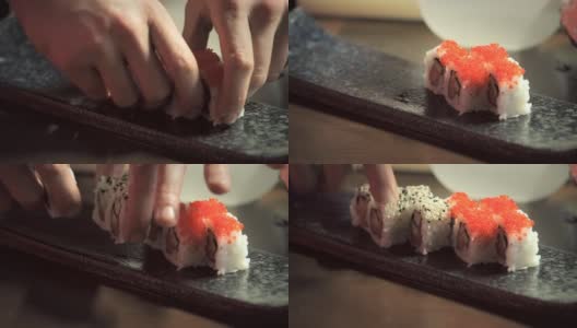 厨师的手把加利福尼亚卷放在寿司盘上高清在线视频素材下载