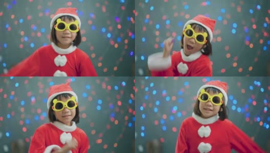 亚洲女孩戴着圣诞老人的帽子跳舞高清在线视频素材下载