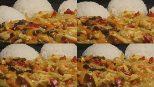 美味的亚洲食物，煮熟的米饭在盘子里慢慢旋转，里面装满了蔬菜高清在线视频素材下载