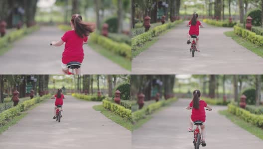 快乐的亚洲女孩在公园里骑自行车高清在线视频素材下载