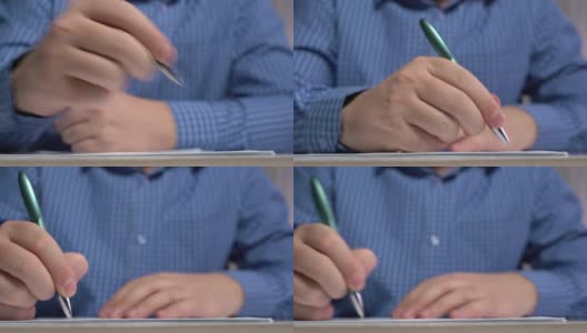 时间圈手用钢笔把课文写在纸上。前视图。特写镜头高清在线视频素材下载