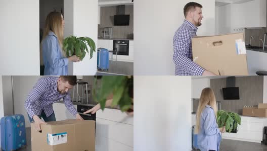 一个兴高采烈的年轻女人手里捧着花走进新房，她的丈夫提着一个装着房产的大箱子高清在线视频素材下载