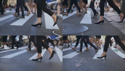 近景时尚女性的脚。女商人正在拥挤的市中心过马路。慢动作高清在线视频素材下载