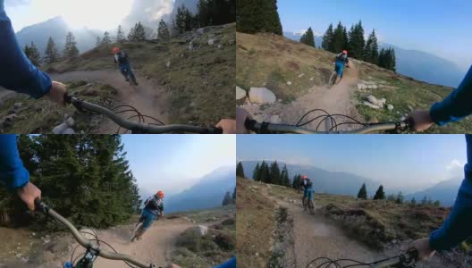 当太阳落山时，骑山地车的人沿着高山坡下山高清在线视频素材下载
