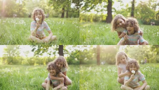 快乐的学生们，男孩和女孩，在夏季的林间空地上玩耍。他们拥抱着，吹着蒲公英，开心地笑着。动态视频高清在线视频素材下载