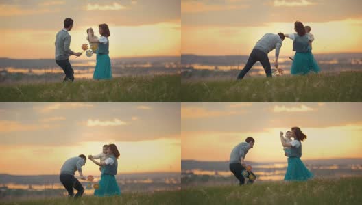 年轻的夫妇和一个孩子跳舞，在自然和日落的乐趣高清在线视频素材下载
