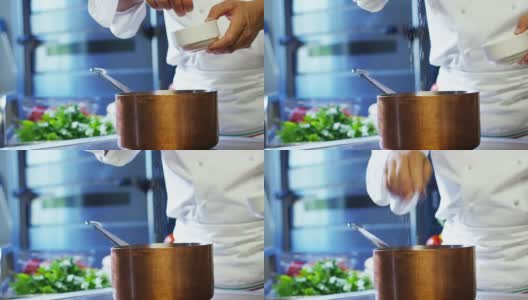 在意大利的专业厨房里，厨师将盐倒在菜上或水里煮熟，这是意大利面食的健康和清淡的食物概念。高清在线视频素材下载