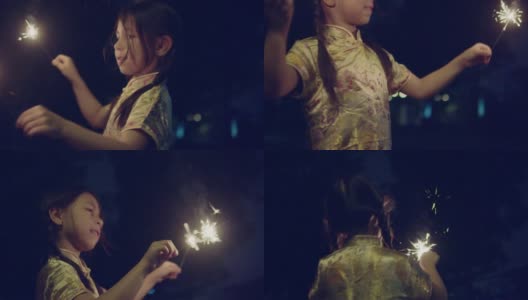 小女孩穿着中式服装，在晚上戴着一个闪闪发光的饰物。高清在线视频素材下载