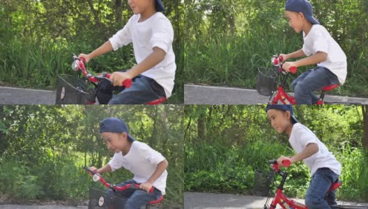亚洲小男孩在花园里学骑和摔倒自行车，学骑自行车高清在线视频素材下载