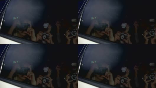 明星夫妇躲在车里，用手挡住杂志摄影师的镜头高清在线视频素材下载