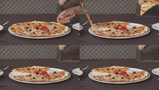 两只手拿一片披萨。人们在吃意大利菜。饮食概念高清在线视频素材下载