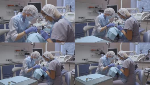 总体计划两名女牙医执行病人的牙齿手术，现代牙科，医疗设备，计算机高清在线视频素材下载