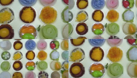 特写俯视图五颜六色的泰国甜点分类在纸盒。高清在线视频素材下载