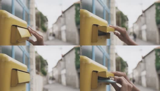 一位女士正在把一封蓝色的信投进一个黄色的信箱高清在线视频素材下载