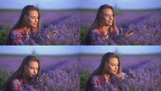 女孩的手抚摸着，嗅着田野里紫色的薰衣草花。高清在线视频素材下载
