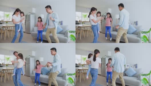 亚洲幸福家庭在客厅一起听音乐和跳舞。漂亮的父母，母亲和父亲花时间与年幼的孩子，女儿在家里。家庭活动关系概念高清在线视频素材下载