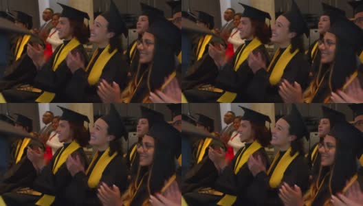 一群年轻的毕业生在毕业典礼上鼓掌，看起来都很开心高清在线视频素材下载