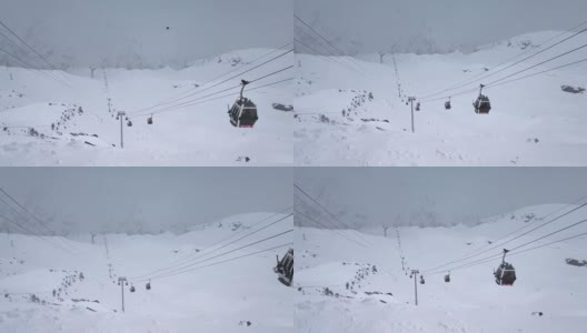 18.04.2021俄罗斯特斯科尔慢动作。山顶积雪和滑雪场缆车的俯视图高清在线视频素材下载