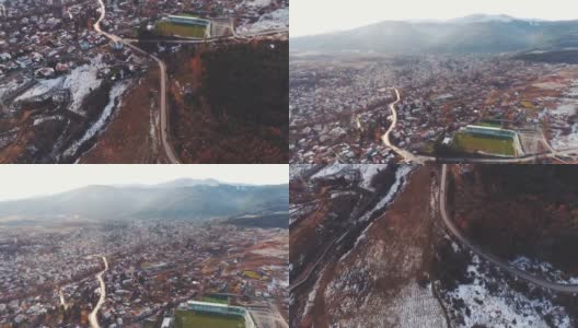 像电影一样宽的无人机拍摄，展示了雪山底部的一个小村庄高清在线视频素材下载