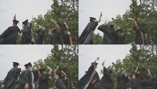 一个亚洲男孩穿着黑色长袍祝贺毕业。高清在线视频素材下载