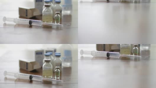 注射疫苗注射器与小瓶医疗近距离白色背景和木制桌子高清在线视频素材下载