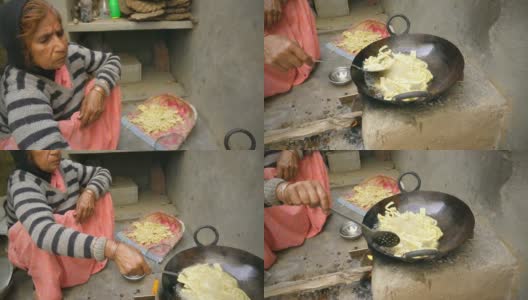 印度妇女在土坯炉上烹饪传统小吃。高清在线视频素材下载
