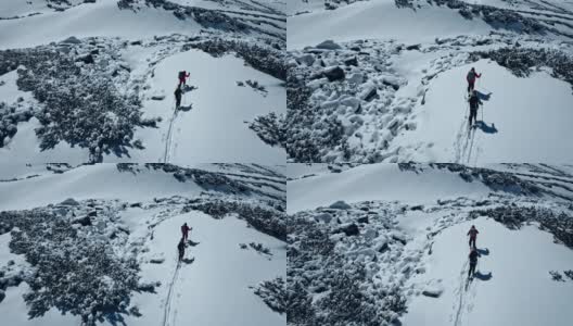 一对夫妇在山间小径上。冬季滑雪旅游。鸟瞰图高清在线视频素材下载
