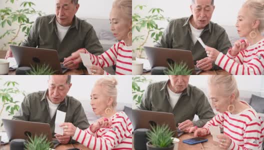 年老的亚洲夫妇在做家庭财务高清在线视频素材下载