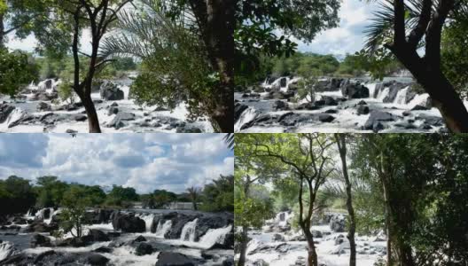 穿过非洲森林，向河流激流和水流通过黑色岩石Aeria视频高清在线视频素材下载