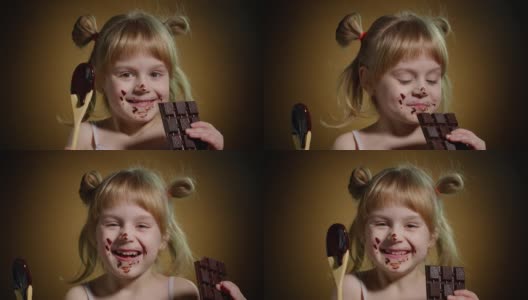在工作室的黑暗背景上，快乐的微笑的孩子和孩子的女孩从融化的巧克力脏脸高清在线视频素材下载