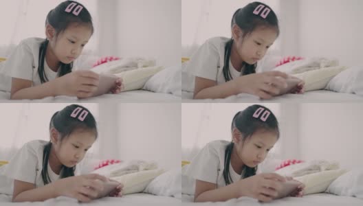 亚洲小女孩白天躺在床上用手机放松高清在线视频素材下载