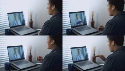 一名亚洲男子在家庭办公室用笔记本电脑与客户视频通话。高清在线视频素材下载