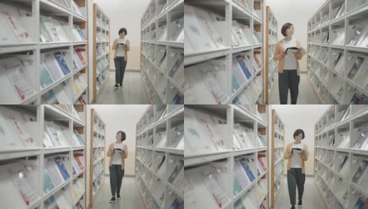 亚洲妇女在图书馆找书高清在线视频素材下载