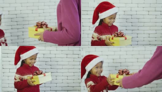 亚洲可爱的小女孩收到来自她父母的礼品盒。高清在线视频素材下载