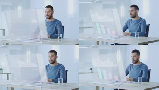 在不久的将来，一个人坐在他的工作站，在他的透明显示器的现代计算机上工作。显示使用交互式图表和图形显示用户界面。高清在线视频素材下载