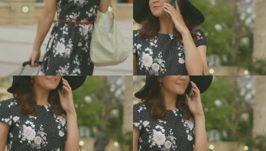 迷人的女性走在街上，带着行李，用智能手机聊天高清在线视频素材下载