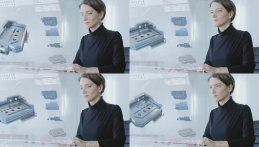 在不久的将来美丽的女工程师工作在她的电脑透明显示。她构建了复杂的三维模型。办公室是明亮和现代的。高清在线视频素材下载