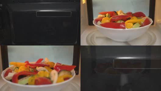 使用微波炉烹饪食物。用微波炉加热蔬菜沙拉高清在线视频素材下载