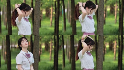 美丽的中国女孩在白色衬衫将她的黑色长发扎成马尾辫在阳光明媚的夏日森林，美丽，生活方式概念，4k镜头，慢动作。高清在线视频素材下载
