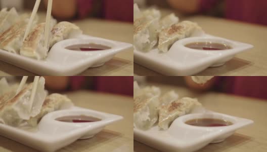 Woman dipping dumplings in soysauce高清在线视频素材下载