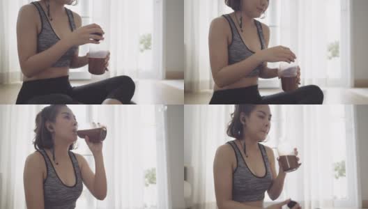 在家锻炼后喝蛋白质奶昔的健康女性高清在线视频素材下载