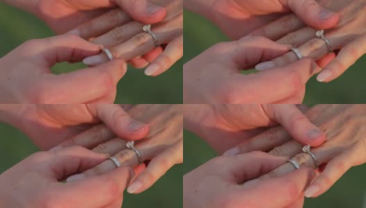 在婚礼上，新郎把戒指戴在新娘的手上。高清在线视频素材下载