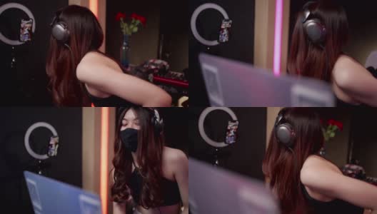 戴着黑色面具的亚洲女性dj在笔记本电脑和转盘上播放音乐，戴着面具的亚洲女性在俱乐部调音隔离新冠病毒，在线直播演出，在线自由职业者工作高清在线视频素材下载