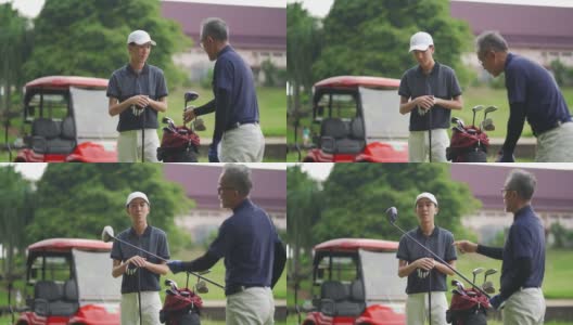一位亚裔华人父亲在高尔夫球场教儿子打高尔夫球高清在线视频素材下载