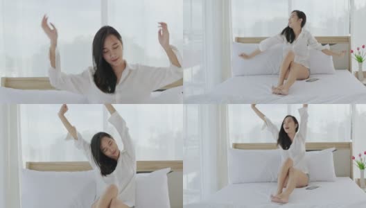 美丽的亚洲女人在她的床上伸展自己的早晨。高清在线视频素材下载