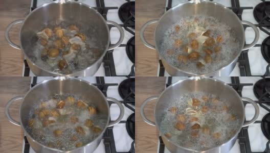 在家庭厨房里，一名男子将装在贝壳里的花园蜗牛扔进一锅沸水里。烹饪健康食物的概念。欧洲菜。没有人。4 k。高清在线视频素材下载